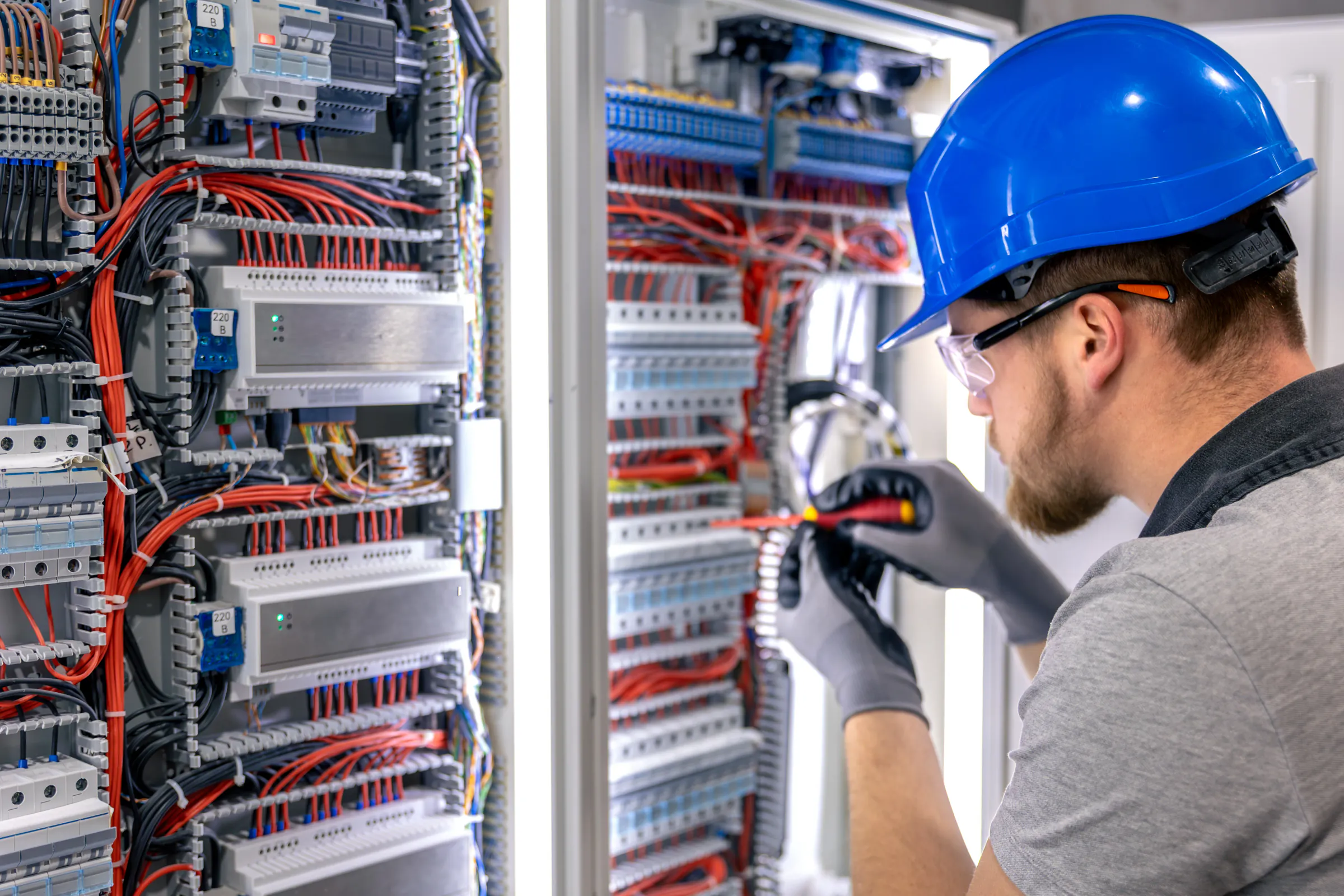 Warehouse with racks of electrical cables, panels, and industrial materials.